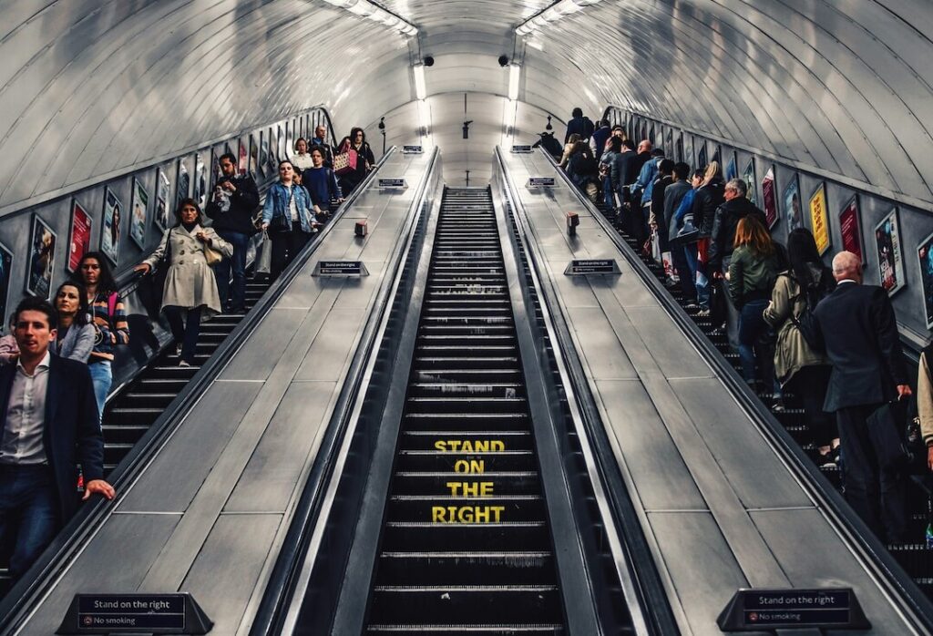 People using escalators in a subway metro.