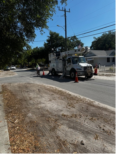 Power line next to a truck and workers 